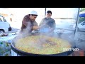 Popular Uzbek pilaf in a big pot l Street food in Uzbekistan