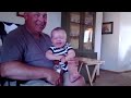 Baby laughing at paper with Grandpa!!!