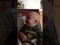 Baby laughing at dad hitting himself in the head with a cookie sheet
