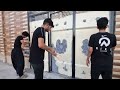 Painting the yard door by Khosrow and Narges