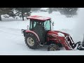 Front mounted hydraulic snow blower on tractor with PTO mounted hydraulic power unit.