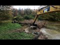 Cleaning up a pond with a CAT 311B excavator.