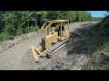 Cutting in driveway drainage with bulldozer