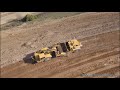 Digging new landfill cell with fleet of Caterpillar scrapers (Part 1)