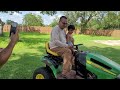 Cortez and Papa riding on the John Deere