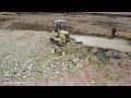 Started up project!! Bulldozer pushing stone to the field make foundation with dump trucks