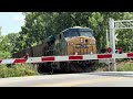 CSX Locomotives pull long train across Railroad Crossing 7/31/24