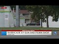 Police respond to barricade situation inside gun shop in Hampton