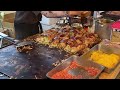 japanese street food - hiroshima style okonomiyaki stall お好み焼き