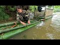 The girl quickly completed the roof of the bamboo house, in the pouring rain.