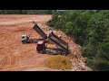 Nice Team Work Filling  Land by Operator Bulldozer Spreading Stone and many Dump Truck Loading Stone