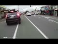 Car cuts across cyclelane with cyclist in it