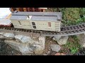 Repairing broken ties on G scale tracks using replacement ties and a work train.