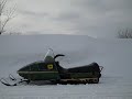 Large snow drift + John Deere snowmobile