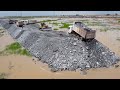 Filling the lake to make a new road easier to pass from one area to another using heavy machinery