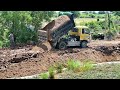 New project Bulldozer Komatsu D31P filling up deep land and farm with dump truck in actions