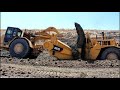 CAT 657 Scrapers Digging New Landfill Cell