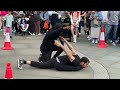 Two people performing some very fascinating dancing in Piccadilly Circus, London