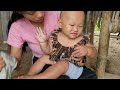 Single mom - A sick baby picks medicine to bathe the baby.