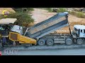 Amazing road construction scene in a rural area  safety operate pavement machinery spreading gravel