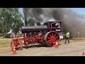 A parade of Antique steam powered traction engines and more .