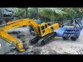 ឡានដឹកអាអុិច MAN ជាមួយអាអុិច KOMATSU ចុះស្តាប្រឡាយក្រោយផ្ទះ