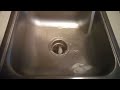 Running ice down the sink with hot water