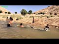 Washing the puppy in the village river:nomadic life and rural life:nomads of iran:village life,river