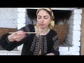 Woman is cooking traditional meat jelly in village oven. Natural Ukrainian Aspic (Kholodets)