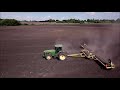 John Deere 8100 pulling land roller