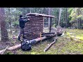 Building a log hut to survive in a wild forest. Bushcraft camping in the wild