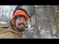 Tractor working in the snow, grading and making Firewood.