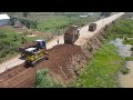 The Fixation Road By Machines Bulldozer And Many Dump Truck In Range  Pouring Soil