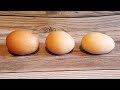 3 eggs sitting in a wood board