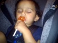 Baby enjoys his candy in sleep