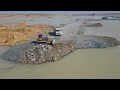 Extreme Bulldozer Clearing Rock And Nice Work Dumper Truck In Project Road Construction On Water