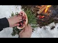 Building a Warm Winter Shelter. Winter camping in the forest. Campfire Steak