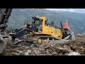 Komatsu D375A-8 and Volvo EC750E extracting rocks