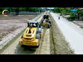 A construction site with a yellow SANY MOTOR Grader & a dump truck working on grading the dirt road
