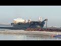 UNLOADING SAND FROM THE SHIP