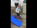 Leo playing with new scooter