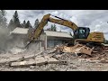 Caterpillar excavator crushes entire retail building