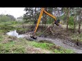 Beaver dam removal with excavator.