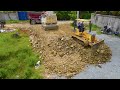 The Road Construction Sever By Bulldozer KOMATSU And Trucks 5ton Clearing Rock Pouring Dirt