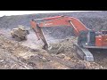 Hitachi Zaxis 650 LC excavator loading rock into dumpers