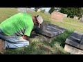 Cemetery shop repairs a broken vault.